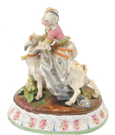 A Continental bisque porcelain figure of a female and goat, over painted with flowers and swags, on an oval foot, 21cm high. (AF)