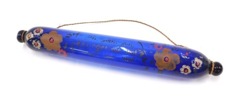 A Victorian Bristol blue glass rolling pin, with painted decoration inscribed Forget Me Not, 39cm wide.