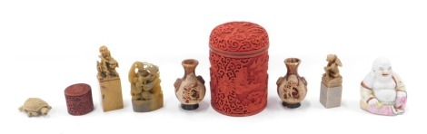 Various oriental ceramics, comprising a red lacquered and blue enamel lined jar and cover, 13cm high, various carved soapstone figures, a pair of oriental Studio Pottery vases, 8cm high. (8)