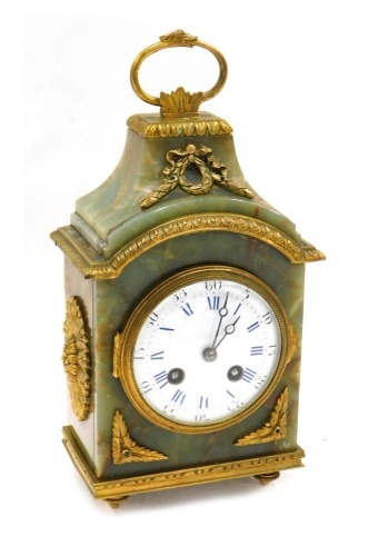 A late 19thC French onyx and gilt metal Pendule D'fficeur, the white enamel dial with blue Roman numerals, the case embellished with reeds, leaves, etc., on bun feet, 29cm high.