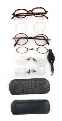 A group of 20thC spectacles, some in leather cases, comprising red tortoiseshell frames, and a tortoiseshell cased monocle.