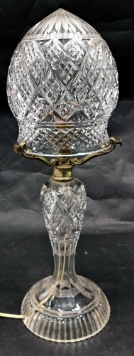 A cut glass table lamp, with a domed shade, baluster shaped stem and tapering foot, 47cm high. WARNING! This lot contains untested or unsafe electrical items. It is supplied for scrap or re-conditioning only. TRADE ONLY