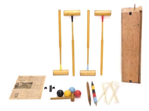 An ash croquet set, with four mallets, balls, etc., repainted, in associated case.