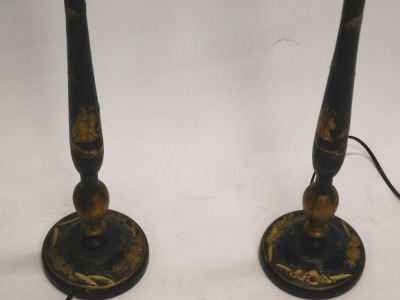 A pair of Japanned table lamps, each decorated in gilt with Oriental figures, landscapes, etc., on a black ground, 75cm high to top of fitting. WARNING! This lot contains untested or unsafe electrical items. It is supplied for scrap or re-conditioning on - 3