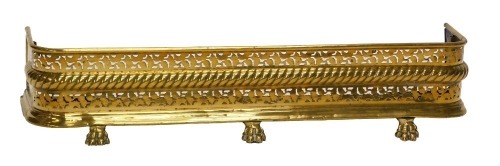 A late 19th/early 20thC brass fender, with a pierced border above a gadrooned band, on paw feet, 109cm wide.