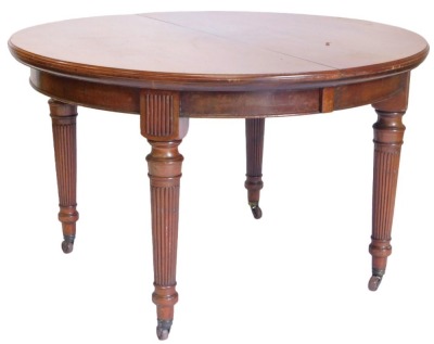 Withdrawn pre-sale. An early 20thC mahogany extending dining table, with rounded ends, moulded edge and a plain frieze, on turned tapering reeded legs with ceramic castors, three loose leaves, 74cm high, 120cm wide, 226cm long.