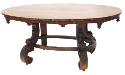 A 19thC rosewood and marquetry centre table, the oval top inlaid with a spray of flowers and leaves, the frieze with turned finials, on shaped leaf and flower carved supports with oval stretcher, 72.5cm high, 61cm wide and 114cm deep.