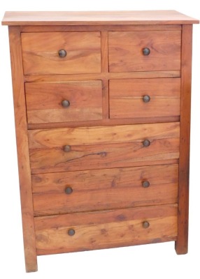 An Eastern hardwood chest of drawers, of plain form with an arrangement of four short and three long drawers, each with turned handles, on stiles, 121cm high, 85cm wide.