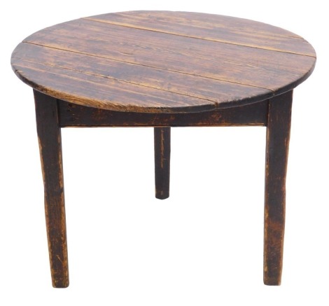 A 19thC stained pine cricket table, the circular plank top on triform tapering legs, 63cm high, 81cm diameter.