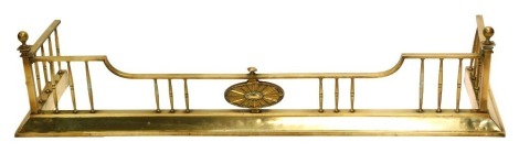 An early 20thC brass fire curb or fender, with turned rails, on a moulded base, 135cm wide.