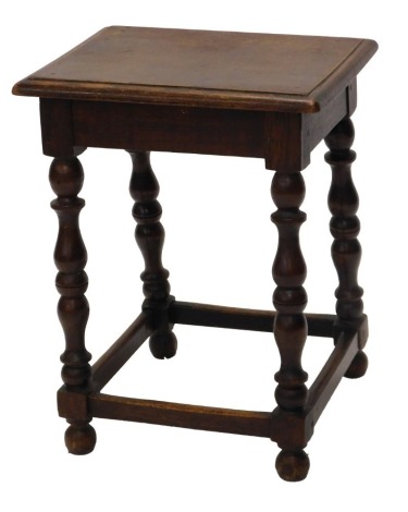 An oak joint stool, the rectangular top with a moulded edge, turned supports, 44cm wide.