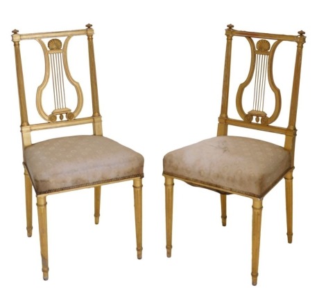 A pair of late 19th/early 20thC gilt gesso side chairs, each with lyre shaped back, padded seat, on turned fluted legs.