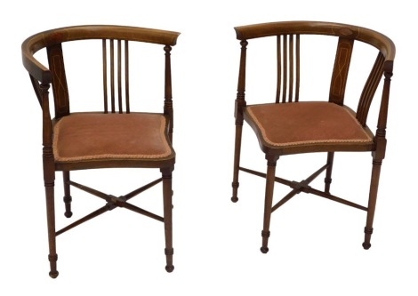 A pair of Edwardian and mahogany boxwood strung corner chairs, each with a padded seat, on turned legs.