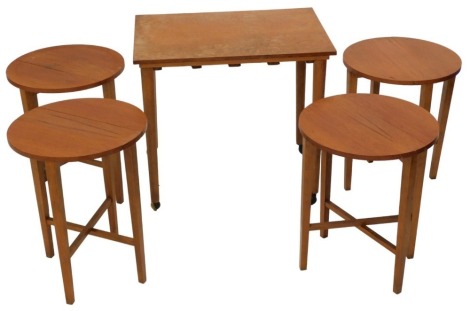 A 1960s/70s teak nest of tables, comprising rectangular table housing four folding drop leaf tables, each with an oval top, the largest table 62cm wide.