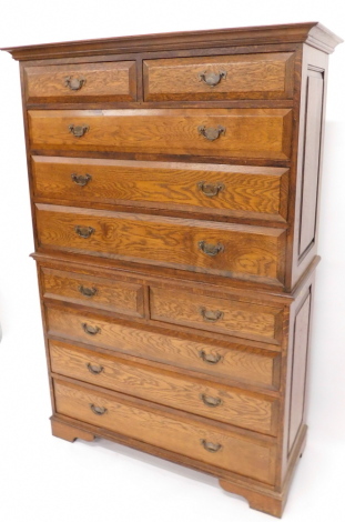 An oak chest on chest, the top with a moulded cornice above two short and three long drawers to base, with a further arrangement of two short and three long drawers, on bracket feet, 170cm high, 116cm wide.