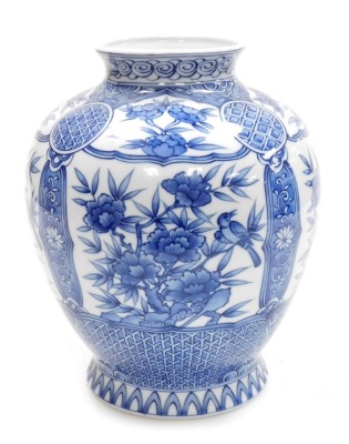 A Japanese porcelain globular blue and white vase, on flared foot, decorated with panels of flowers within geometric and floral borders, with four character mark to base, 20th century, 28cm high.