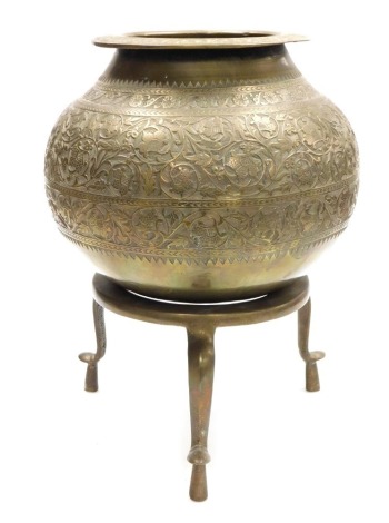 An early 20thC Indian brass vessel on stand, embossed with bands of flowers and scrolling leaves, raised on a circular stand on three cabriole legs, 41cm high.