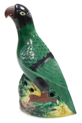 A 20thC Chinese pottery figure of a parrot, green glazed, on a naturalistic ground, with holes to the sides of the base, 36.5cm high. - 2