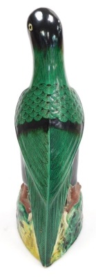 A 20thC Chinese pottery figure of a parrot, green glazed, on a naturalistic ground, with holes to the sides of the base, 36.5cm high. - 5