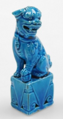 A group of Chinese porcelain and collectables, including a blue glazed dog of fo, two further dogs, and a pair of cloisonne pots and covers formed as fruit. (a quantity) - 7