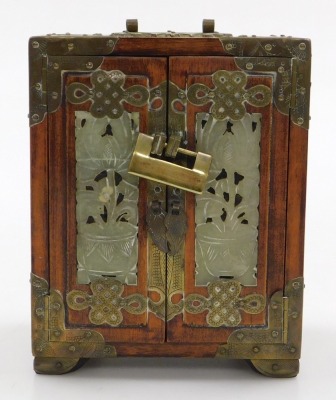 A 20thC Chinese wooden and brass bound table cabinet, with a brass lock, having two doors inset with carved jade panels, opening to reveal three drawers, raised on bracket feet, 18cm high, 14cm wide, 10cm deep (AF), together with a Chinese pillow painted - 2