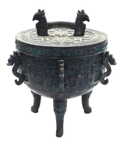 A James Mont Chinese style bronzed ice bucket, formed as an archaic censer and cover, with a verdigris finish, 28cm wide.