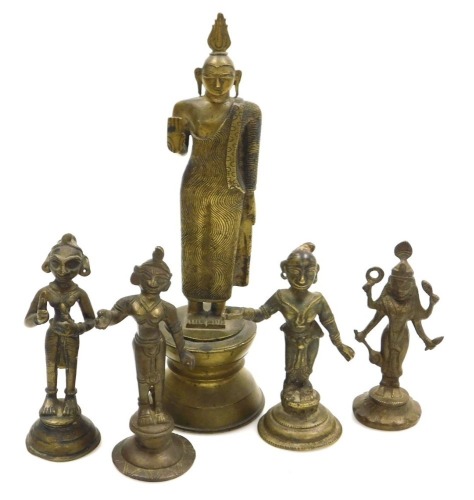 A Sri Lankan brass figure of Buddha, modelled in standing pose, raised on a waisted circular base, 25cm high, and four further brass figures of deities. (5)