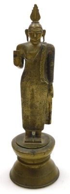 A Sri Lankan brass figure of Buddha, modelled in standing pose, raised on a waisted circular base, 25cm high, and four further brass figures of deities. (5) - 2