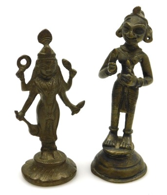 A Sri Lankan brass figure of Buddha, modelled in standing pose, raised on a waisted circular base, 25cm high, and four further brass figures of deities. (5) - 7