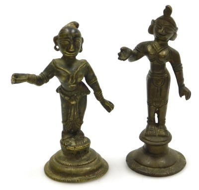 A Sri Lankan brass figure of Buddha, modelled in standing pose, raised on a waisted circular base, 25cm high, and four further brass figures of deities. (5) - 10