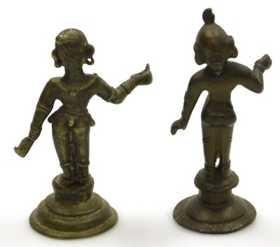 A Sri Lankan brass figure of Buddha, modelled in standing pose, raised on a waisted circular base, 25cm high, and four further brass figures of deities. (5) - 11