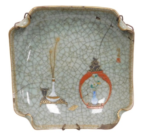 A Japanese crackle glazed dish, of curved, square form, decorated with a vase of peacock feathers on a table, and a jar and cover containing a vase of flowers, signature with seal to the front and six character Chinese style mark to the reverse, 19cm wide