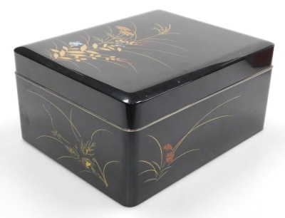 A Japanese black lacquer box and cover, decorated with grasses and flowers, together with a brown lacquer bento box, of two section form, with lid holding a pair of chopsticks, 17.5cm high, 17cm wide, 16.5cm deep. (2) - 4