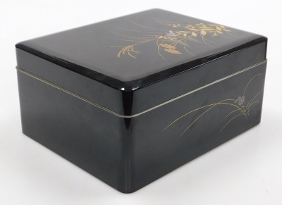 A Japanese black lacquer box and cover, decorated with grasses and flowers, together with a brown lacquer bento box, of two section form, with lid holding a pair of chopsticks, 17.5cm high, 17cm wide, 16.5cm deep. (2) - 5