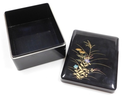 A Japanese black lacquer box and cover, decorated with grasses and flowers, together with a brown lacquer bento box, of two section form, with lid holding a pair of chopsticks, 17.5cm high, 17cm wide, 16.5cm deep. (2) - 6