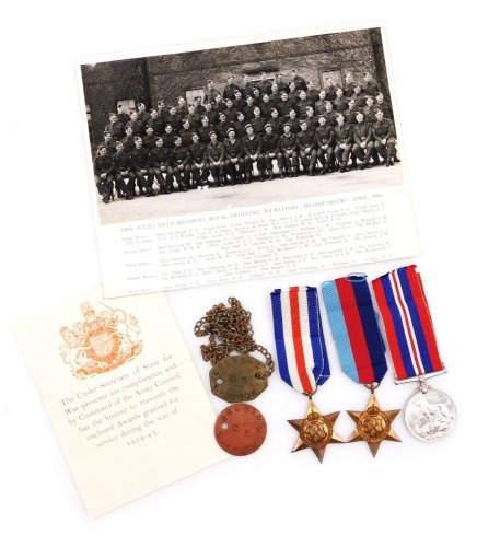 A WWII medal group, comprising 1939-45 British War medal, 1939-45 Star and the France and Germany Star, as issued to 6856342 C E L Spoor, with two dog tags and 150th Field Regiment Royal Artillery photograph April 1944, and two dog tags (son of Pte. J Spo