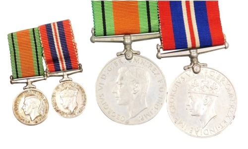 A WWII medal pair, comprising 1939-45 British War medal and Defence medal, and corresponding miniature dress medals.