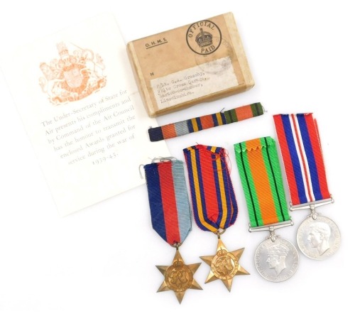 A WWII medal group, comprising 1939-45 British War medal, Defence medal, 1939-45 Star and Burma Star, with original OHMS box, addressed to F/Lt GA Grassby, Barton on Humber, Lincolnshire and tunic ribbons.