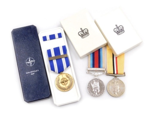 An Operation Service medal and Iraq Medal, and NATO Medal in Service of Peace and Freedom, the Operation Service Medal with Afghanistan ribbon and clasp, and the Iraq Medal both inscribed to 25179710 Pte. AL Cook, Para, with original boxes.