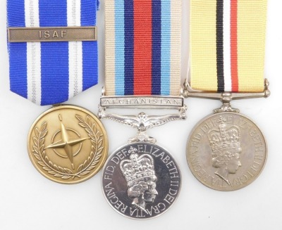 An Operation Service medal and Iraq Medal, and NATO Medal in Service of Peace and Freedom, the Operation Service Medal with Afghanistan ribbon and clasp, and the Iraq Medal both inscribed to 25179710 Pte. AL Cook, Para, with original boxes. - 2