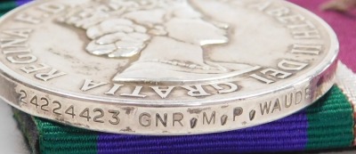 A Queen Elizabeth II General Service and Long Service and Good Conduct medal, General Service medal with Northern Ireland clasp, inscribed to 24224423 Gnr. MP Waude, Royal Artillery, with a set of Royal Artillery brass buttons and cap badge, and two braid - 4