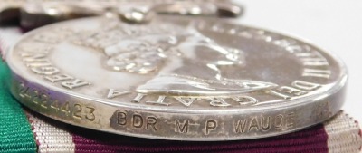 A Queen Elizabeth II General Service and Long Service and Good Conduct medal, General Service medal with Northern Ireland clasp, inscribed to 24224423 Gnr. MP Waude, Royal Artillery, with a set of Royal Artillery brass buttons and cap badge, and two braid - 5