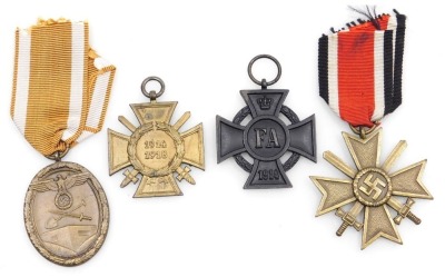 A small collection of German medals, including a German 1914-18 Combatants Cross, Frederick Augustus First Class 1914 Cross (Grand Duchy of Oldenburg for Merit Cross), 1939 Second Class War Merit Cross and a 1939-45 German medal inscribed F Fur Arbeit Zum - 2