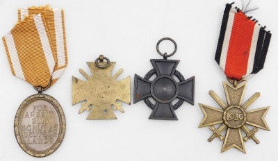 A small collection of German medals, including a German 1914-18 Combatants Cross, Frederick Augustus First Class 1914 Cross (Grand Duchy of Oldenburg for Merit Cross), 1939 Second Class War Merit Cross and a 1939-45 German medal inscribed F Fur Arbeit Zum - 3