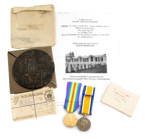 A WWI bronze death plaque and medal pair, the death plaque named to Harold Godber, and the medals inscribed to 306984 Pte H Godber, West Riding Regiment, Killed in Action 3/5/1917, and buried at Arras, with postage envelopes and medal box, with original c