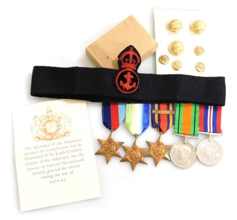 A WWII medal group, comprising 1939-45 British War medal, Burma Star with Pacific clasp, The Atlantic Star and 1939-45 Star an Defence medal, with original packaging, Royal Naval uniform buttons and cap band with embroidered crest.