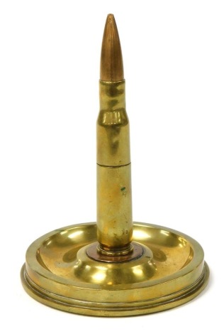 A WWII brass ordnance table lighter, in the form of a shell case lighter, mounted on a twenty-five pound artillery brass shell base.