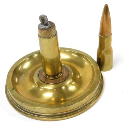 A WWII brass ordnance table lighter, in the form of a shell case lighter, mounted on a twenty-five pound artillery brass shell base. - 2