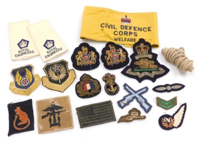 A collection of military cloth badges, including Royal Naval gold braid insignia, 8th Army Desert Rat, Royal Engineers epaulette patches and Civil Defence Corps Welfare arm band, etc.