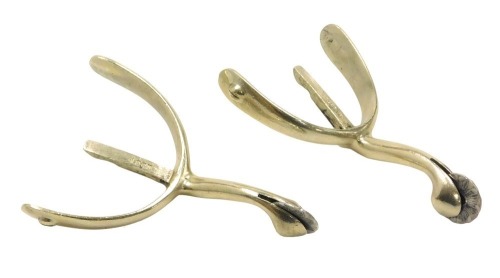 A pair of nickel metal spurs stamped Moss Bros.